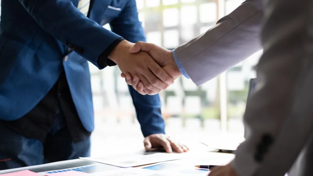 Business professionals shaking hands after an agreement