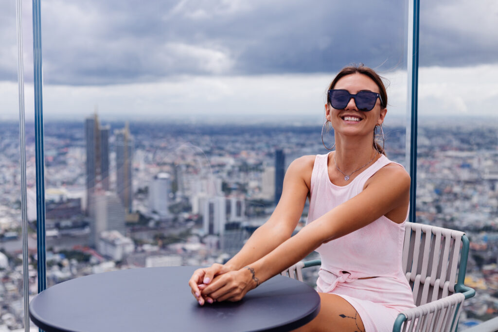 Woman smiling against a panoramic city skyline
